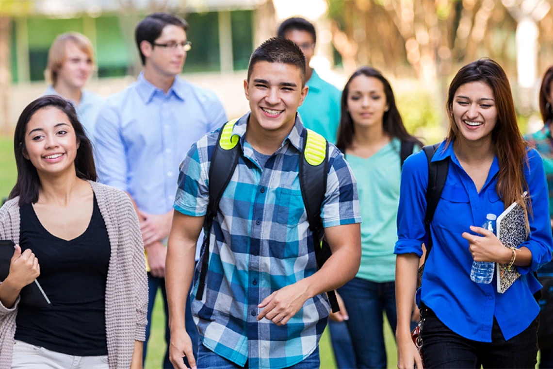 Group of high school students walking and laughing