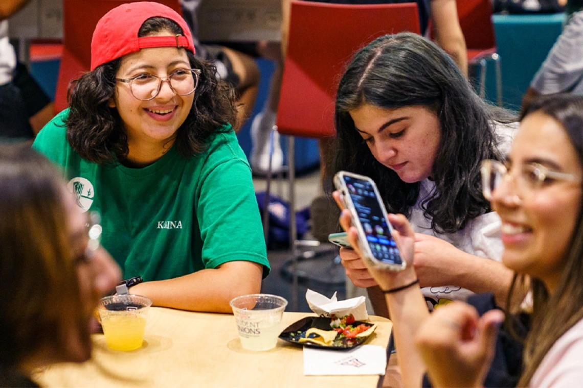 Group of students sitting inside at a table
