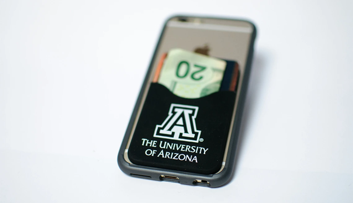 Close up of phone with money clipped to the back of it